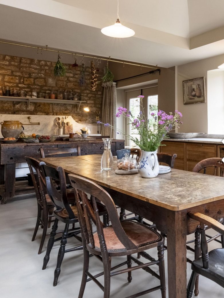 Lapwing House dining room — two-plank sycamore table from a country-house scullery, ironstone wall, antique chairs