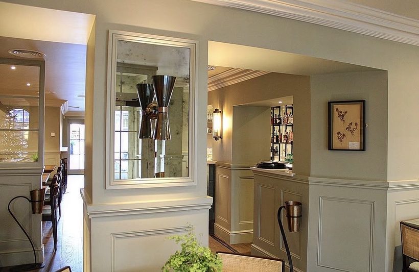 No. 23 — antiqued mirror and cone pendant over the panelled bar