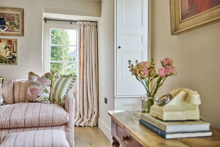 The Shambles — pink striped sofa with layered cushions